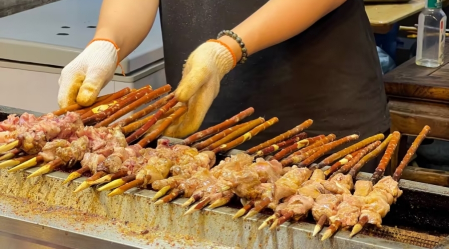 Xinjiang lamb skewers grilled over red willow branches