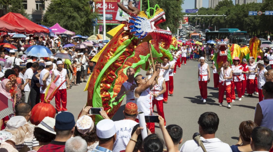 Dragon dance teams perform in front of a mosque to celebrate Eid al-Fitr in Jilin City, Jilin province
