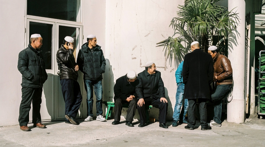 Men waiting for the beginning of the Friday prayer at a Shanghai mosque​