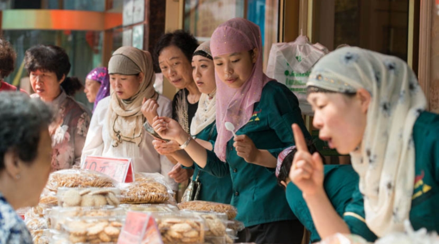 Muslim women sell snacks during Eid al-Fitr near the historic Niujie Mosque