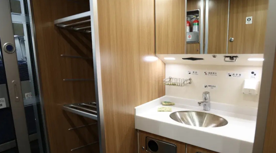 Wash basin and luggage racks in a clean high-speed train carriage in China