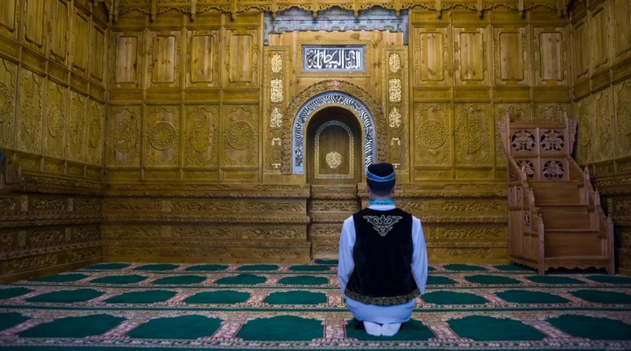 A Salar Muslim offers prayers in a traditional mosque in Qinghai