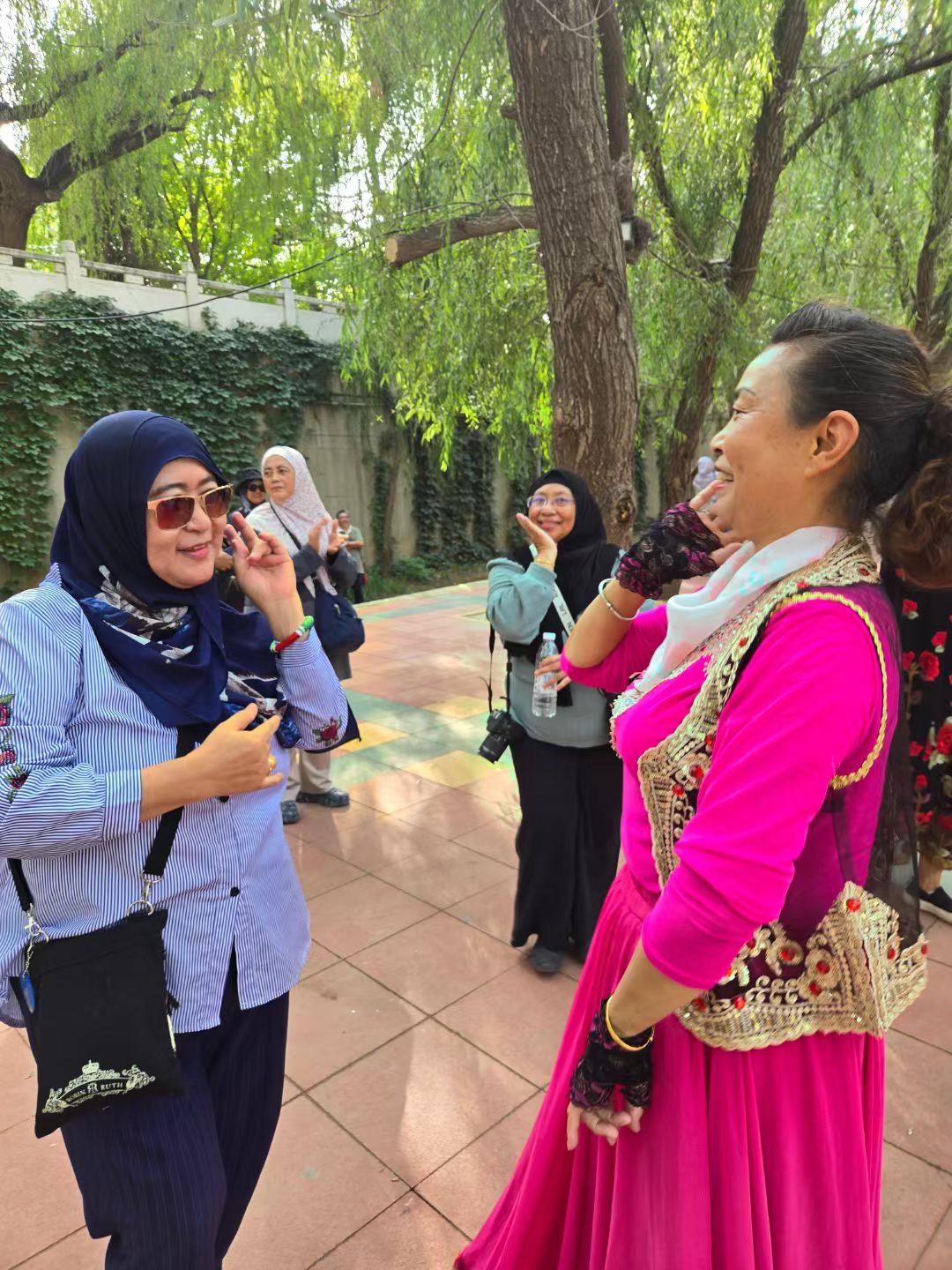 Muslim travelers and local residents share joyful dance gestures